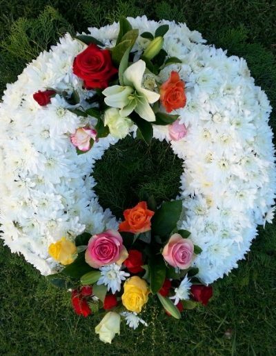 White wreath with coloured sprays